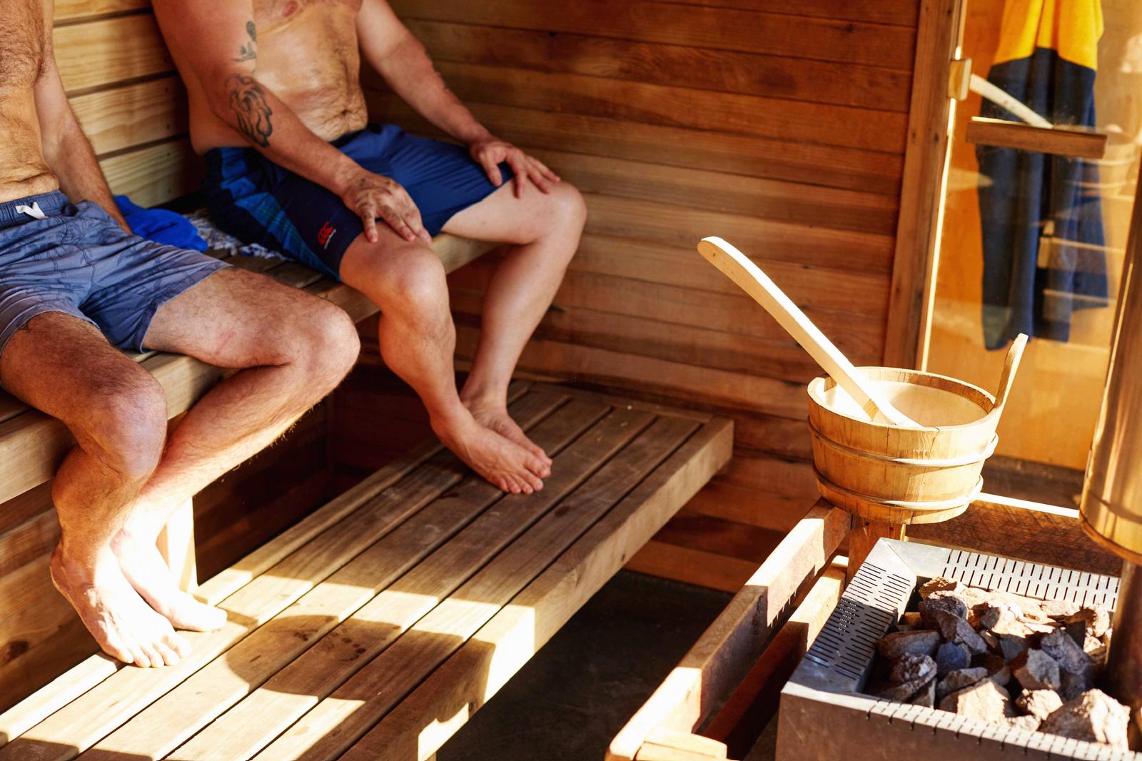 Two guests relaxing together inside the sauna